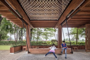 two children playing outside in patio covered by building
