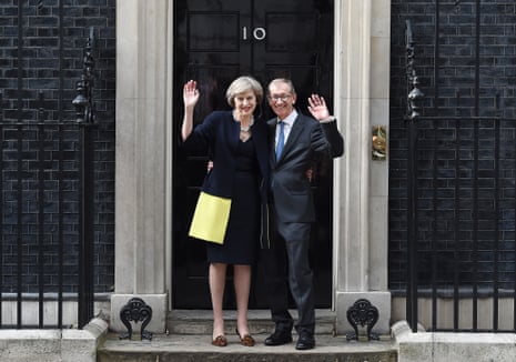 British Prime Minister Theresa May with her husband Philip wave to the media upon their arrival at No. 10 Downing Street