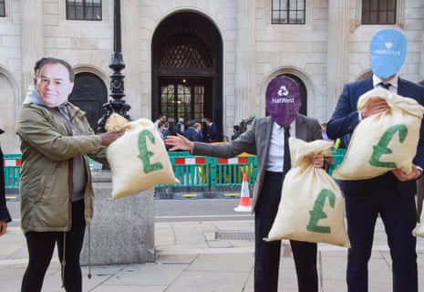 Activists from the group Positive Money donning masks of Rishi Sunak, BOE Governor Andrew Bailey and various banks stage a protest against interest rate hikes and profiteering outside the Bank of England.