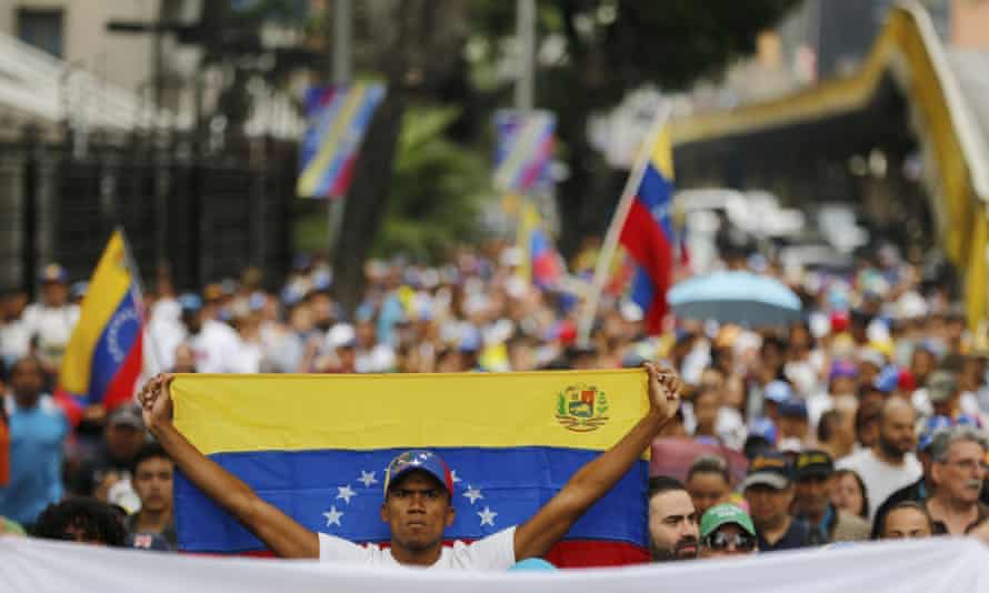 An opposition member holds a Venezuelan national flag during a protest march against Nicolás Maduro in Caracas Wednesday.