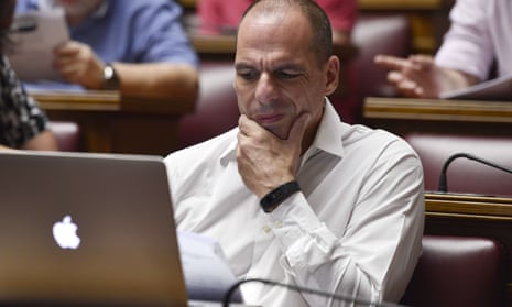 Yianis Varoufakis reads a document during a meeting at the Greek parliament in Athens.