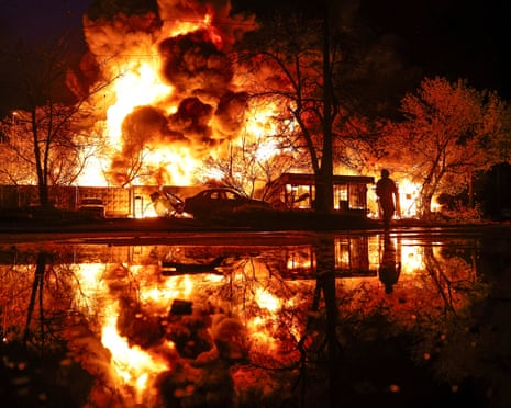 A firefighter works at the site of a recyclable materials warehouse hit by a Russian missile strike in Kyiv on 16 April.