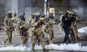 Federal agents use crowd control munitions to disperse Black Lives Matter protesters in Portland, Oregon, this week.