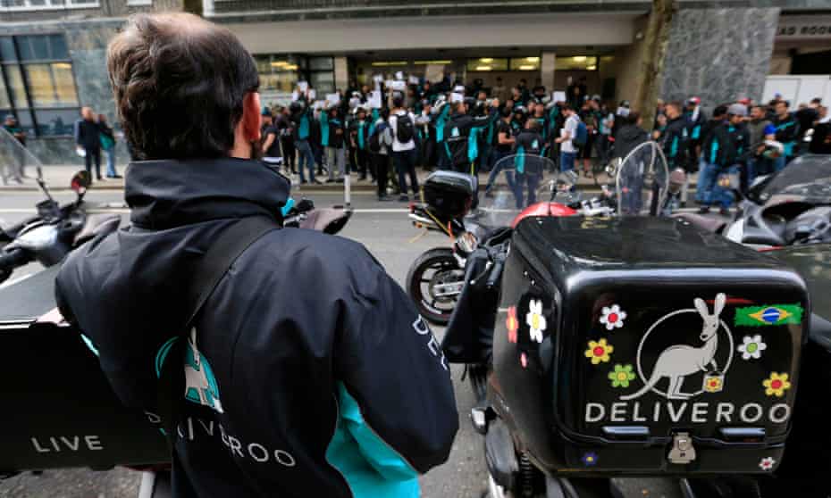 Deliveroo riders holding a protest over pay outside the company's London HQ last month
