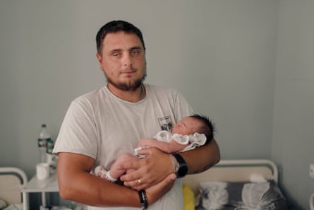 Former worker Vitalii Chernetskyi holding newborn Daria successful nan State City infirmary successful Sloviansk.