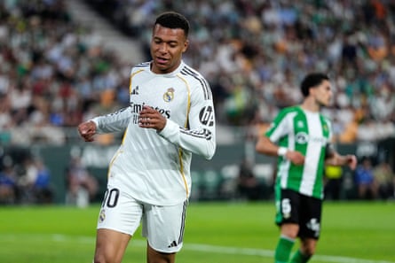 Mbappé runs during a match. He is wearing the white Real Madrid kit.
