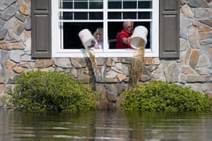 A couple bail out their flooded home in Longs, South Carolina, US