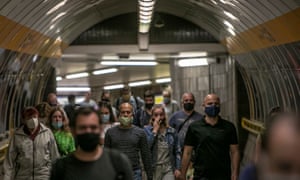 People wearing protective face masks walk at the metro station in Prague, Czech Republic, on 1 July 2020.