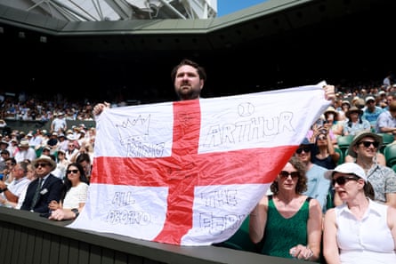An Arthur Fery fan holds up an England flag on centre court.