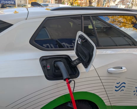 An electric vehicle charges at a public charging station in Munich, Bavaria, Germany.