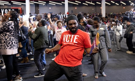An audience member dances during a campaign event with former president Barack Obama, Senator Raphael Warnock and Stacey Abrams in College Park, Georgia, on 28 October 2022.
