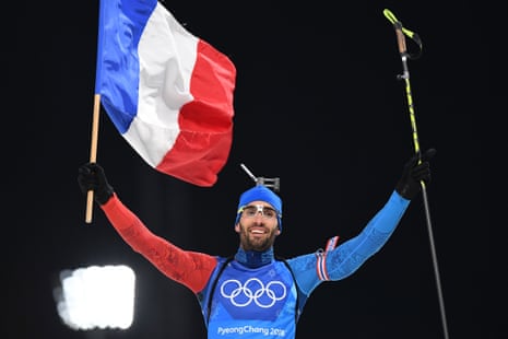 France’s Martin Fourcade cross the finish line to win team gold.