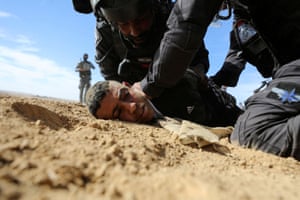 Sawe al-Atrash, Israel. Israeli security forces detain a Bedouin man during a protest against forestation at the Negev desert village