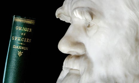 A copy of Darwin’s book the Origin of Species is pictured in front of a lifesize stone bust of the naturalist