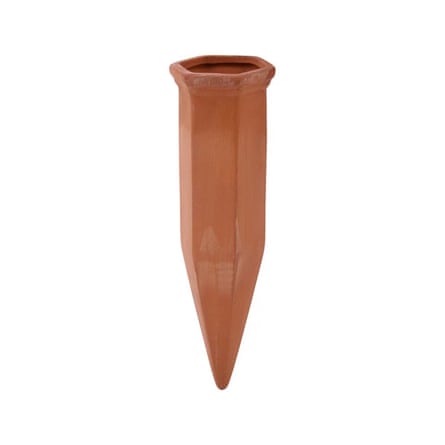 A terracotta water irrigation spike on a white background