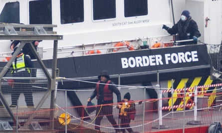 Migrants including women and children are removed from a Border Force vessel after being picked up in the Channel