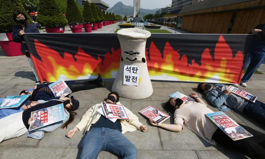 Members of an environmental activist group perform during a rally to call for the dismantling of coal-fired power plants by 2030 as part of efforts to raise public awareness about the harmful effects of coal on people’s health, in Seoul, South Korea,