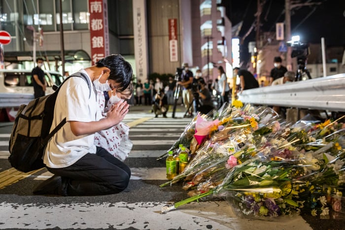 People pray at a site outside of Yamato-Saidaiji dtation where Japan’s former prime minister Shinzo Abe was shot