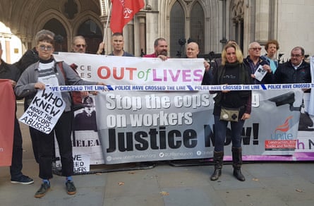 Protesters with a banner reading “Stop the cops spying on workers, Justice Now!”