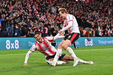 Shea Charles hurls himself on the turf after scoring his extra-time winner