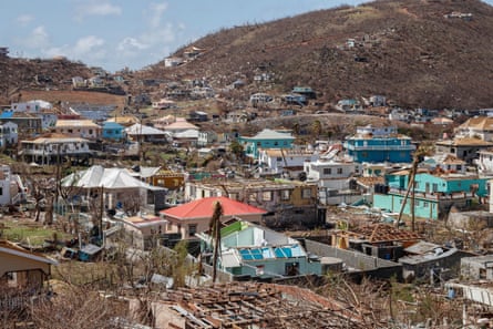 Damaged and destroyed houses in a hilly landscape