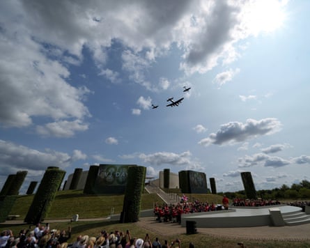 A Lancaster bomber flanked by a Hurricane and Spitfire in the sky over the National Memorial Arboretum