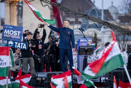 Magyar on stage waving a Hungarian flag