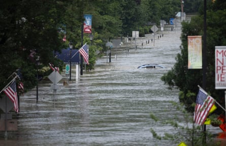 A car swept up in flood waters in Montpelier, Vermont
