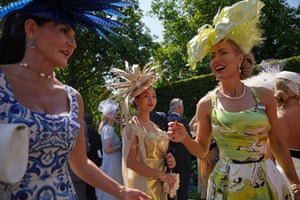 Well-dressed women in ornate hats arrive for Ladies Day at the Royal Ascot race meeting on Thursday.