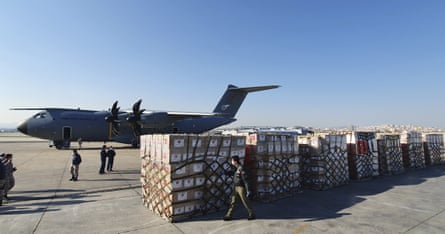 Soldiers prepare to load a military cargo plane with personal protective equipment donated by Turkey to help the US