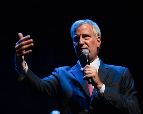 a man in a suit speaks into a microphone