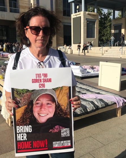 Tamar Goren holds a placard of her kidnapped daughter, Shami, in Jerusalem.