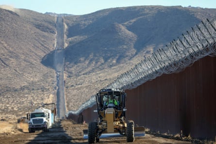 Construction crews work on the US-Mexico border wall in Jacumba, California,  1 December, 2020