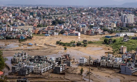 Muddy floodwaters in the middle of a cityscape