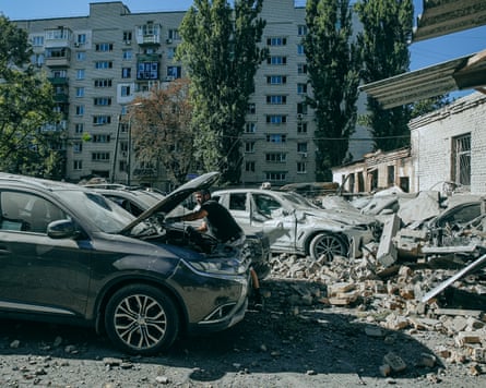 Vitalii, in Kyiv, is checking his damaged car