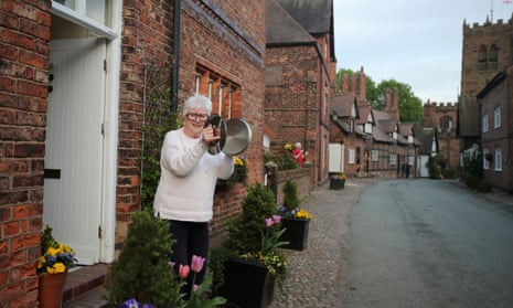 A local resident use pot lids to applaud from her doorstep during the Clap for our Carers campaign in support of the NHS, as the spread of the coronavirus disease continues, in Great Budworth, Britain, April 23, 2020. REUTERS/Molly Darlington