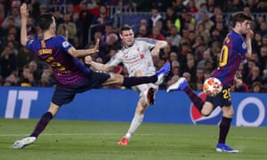 Liverpool’s James Milner shoots pas, Barcelona’s Sergio Busquets, left, and Sergi Roberto, right but he is thwarted by Marc-Andre ter Stegen.