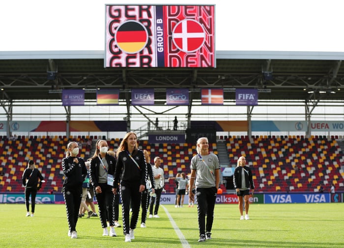 Karen Holmgaard and Pernille Harder of Denmark inspect the pitch.