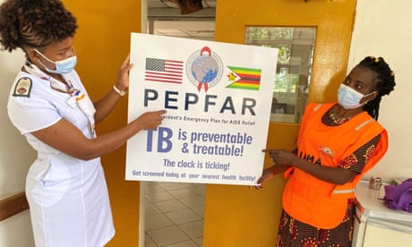 Healthcare workers in Zimbabwe with a poster promoting Pepfar, the US president’s emergency plan for Aids relief.