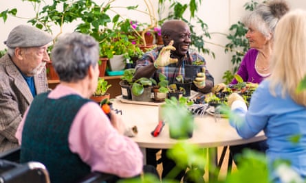 Retired people chatting and gardening together