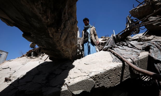 A Yemeni inspects debris of a destroyed building targeted by a previous Saudi-led airstrike on Sanaa.