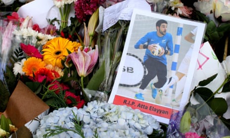 A photograph of New Zealand futsal player Atta Elayyan, victim of the Christchurch mosque attacks, sits amongst floral tributes near the Al Noor mosque.
