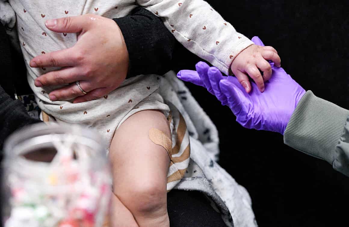 A child holds a gloved hand
