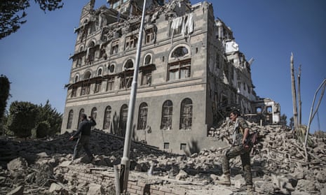 Houthi rebels inspect the rubble of the Republican Palace that was destroyed by Saudi-led airstrikes, in Sanaa, Yemen, in 2017. 