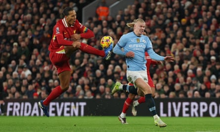 Virgil van Dijk makes an interception to deny Erling Haaland at Anfield.