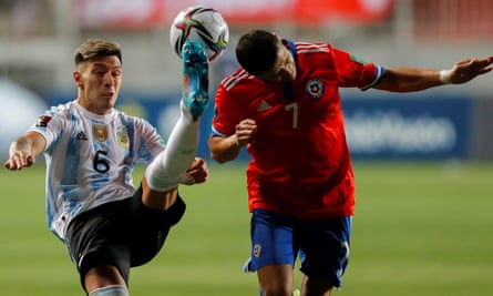 Lisandro Martínez gets his foot to the ball while contesting possession with Chile’s Alexis Sánchez during a World Cup qualifier with Argentina