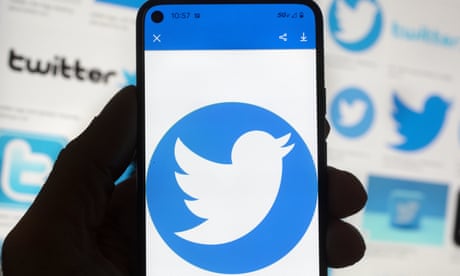 The Twitter logo is seen on a cell phone