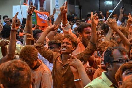 A group of men celebrate outside after an election
