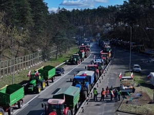 Protesting farmers block a road with tractors and trailers
