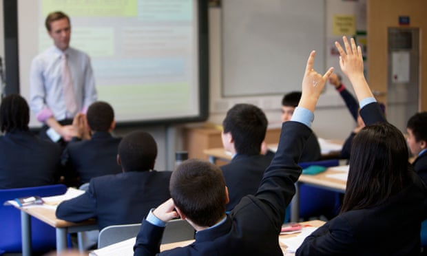 Teacher takes a class at a modern secondary school in London, UK.